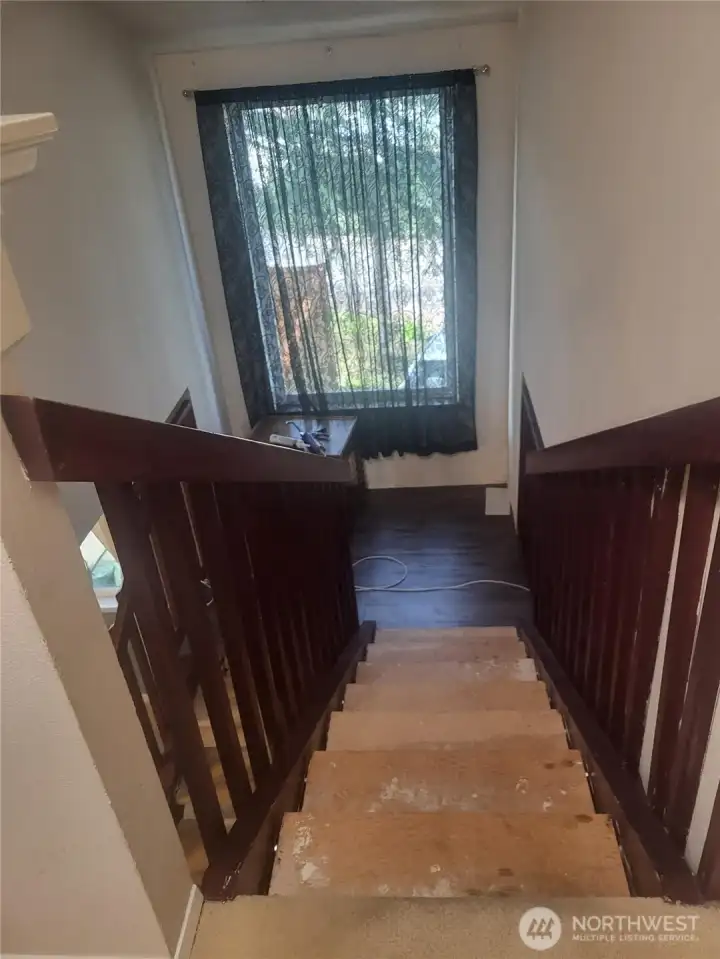 Stairwell going downstairs, needs flooring.