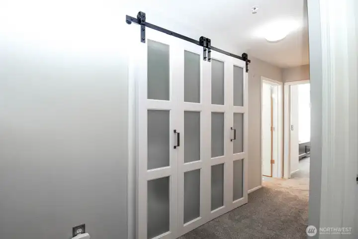 Laundry, with door closed, in hallway