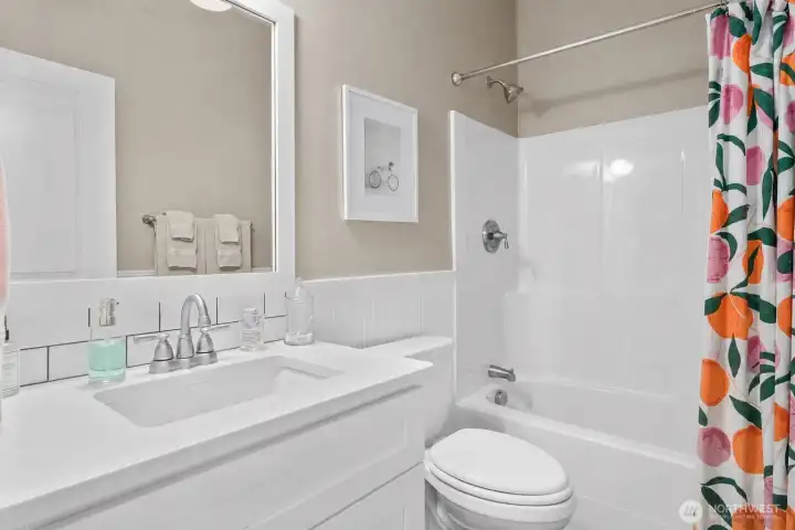 Lower floor bathroom with clean, modern finishes and convenient access for guests and everyday living.