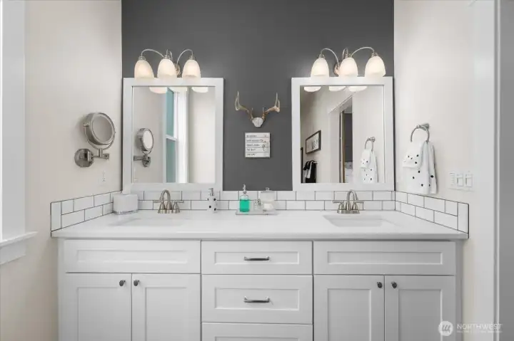 Bright primary ensuite with dual vanities, classic finishes, and generous storage.