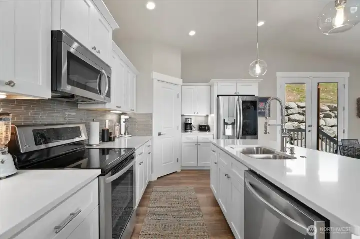 The kitchen features an LG appliance suite, generous storage, and a walk-in pantry.