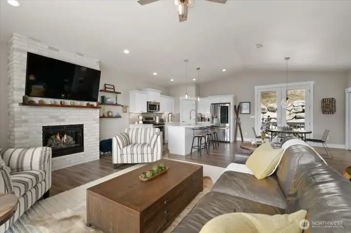 Spacious upper-level gathering spaces with vaulted ceilings, fireplace feature, and an open layout designed for both entertaining and everyday living.