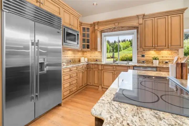 Kitchen is one of the largest at The Reserve with double Dacor ovens, Subzero fridge, quartz, travertine tile, walk-in pantry and water filtration system.