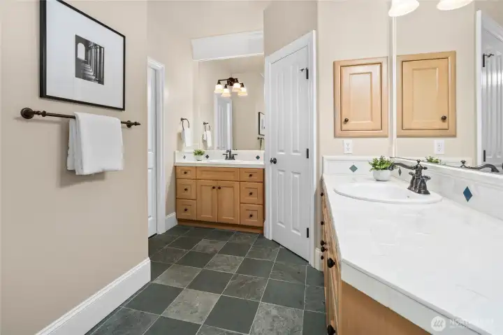 Upstairs full hallway bathroom with 2 sink areas seperated from shower & tub/toilet area