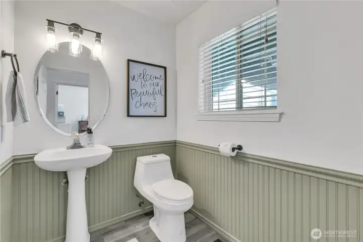 Powder bath off the foyer for guests and convenience with charming wainscotting. Powder bath off the foyer for guests and convenience with charming wainscotting.