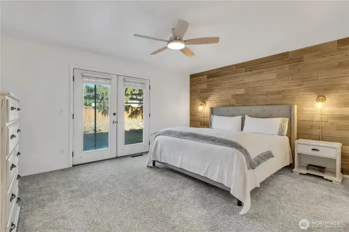 Primary suite with french doors to the patio, ceiling fan & en-suite bath Primary suite with french doors to the patio, ceiling fan & en-suite bath