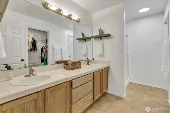En-suite primary bath with dual vanity and walk in closet En-suite primary bath with dual vanity and walk in closet