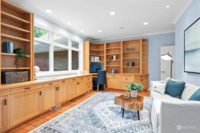 Experience productivity and style in this beautifully appointed home office, featuring custom built-in cabinetry that blends form and function. The elegant cabinetry provides ample storage and organization for books, documents, and office essentials, creating a clutter-free and efficient workspace.