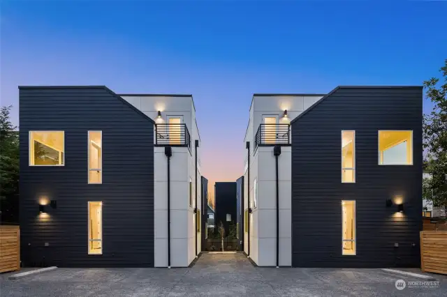 Stylish symmetry and bold lines define these twin residences, set against a breathtaking sunset backdrop.