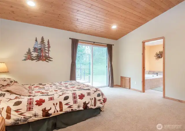 Primary bedroom with access to the private back deck.