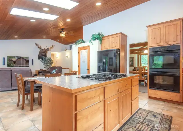 Open great room with an island kitchen and pantry.