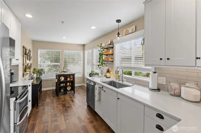 Beautifully updated kitchen featuring modern cabinetry, sleek countertops, stainless steel appliances, and under-cabinet lighting for a stylish, functional finish