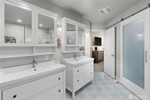 Stunningly updated primary bath complemented by a one-of-a-kind walk-in closet.