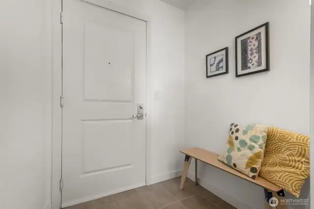 The tile-floored entry alcove of Unit 655 offers a gracious welcome, complete with space to pause, sit, and settle in on your own choice of seating arrangement.