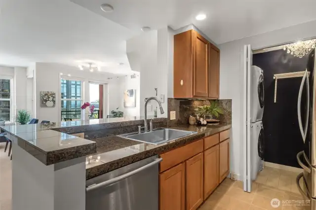 From the heart of the kitchen, enjoy open-concept living with stunning views of the dining area, office nook, and a majestic cruise ship docked beyond.