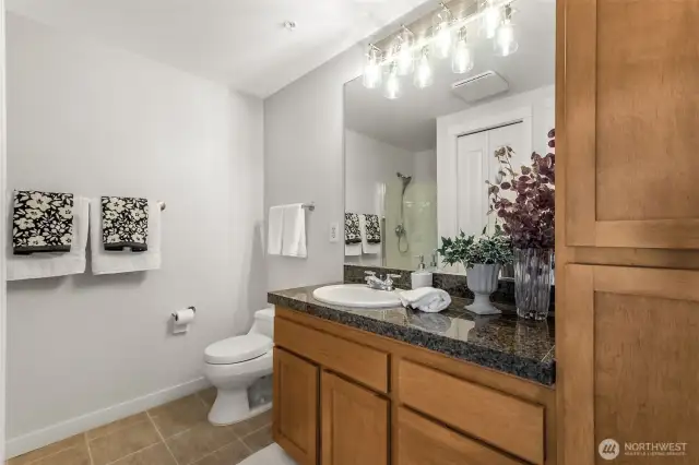 Bathroom #2 shines with refreshed vanity lighting, adding a modern touch to this spacious stylish 3/4 bath.