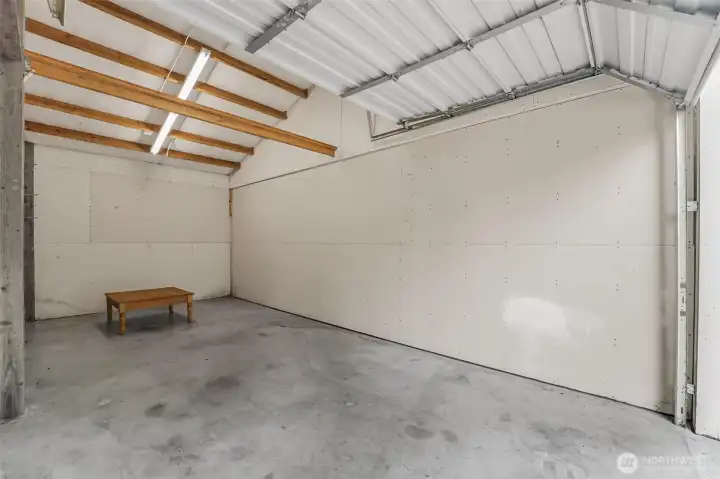 Owner has divided the garage into 3 bays. You should be able to remove the sheetrock and open it up to 1 big shop.