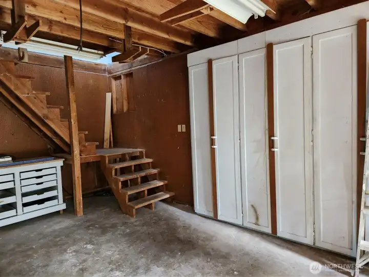 Built in cabinets in the garage. Stairs leeding to the loft
