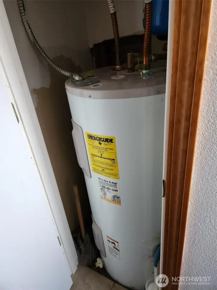 Hot water tank in bathroom closet.