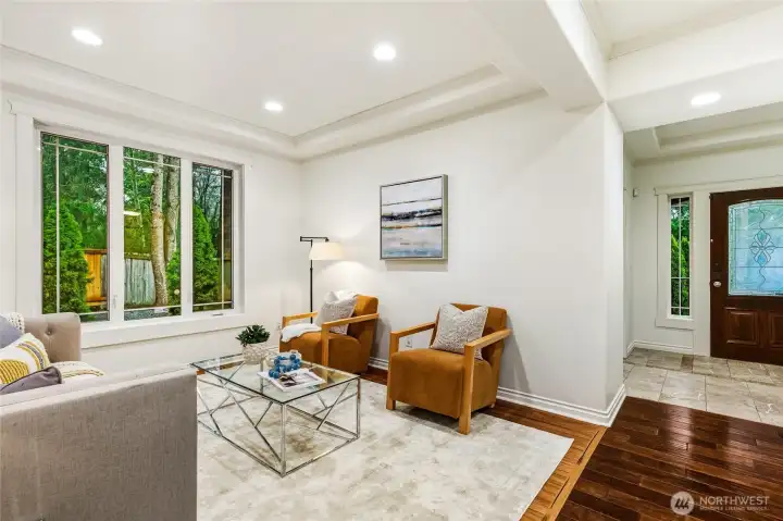 Formal living room with with recessed lighting and ceiling detail.