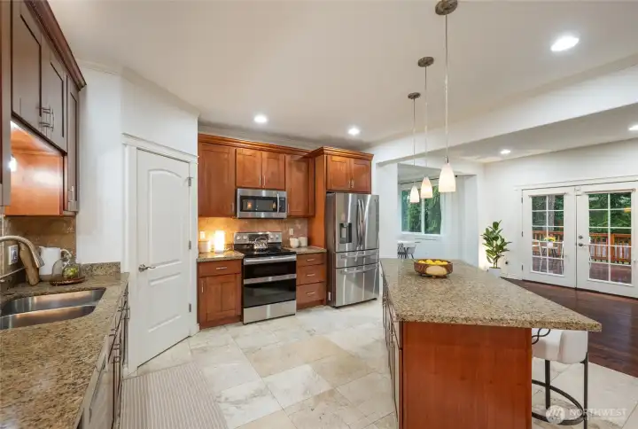 Extensive cabinetry, pantry, granite counters & full-height tile backsplash are just a few of the amazing touches in this kitchen.