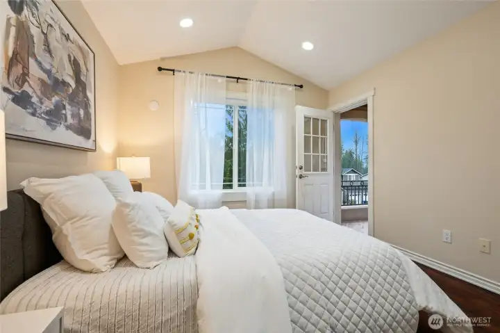 Luxurious vaulted ceilings and private deck in this bedroom!