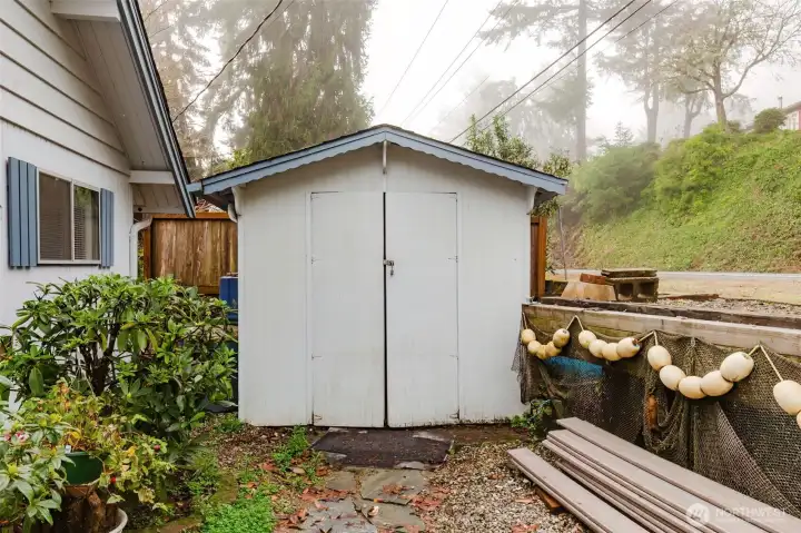 Outbuilding housing washer, dryer and storage