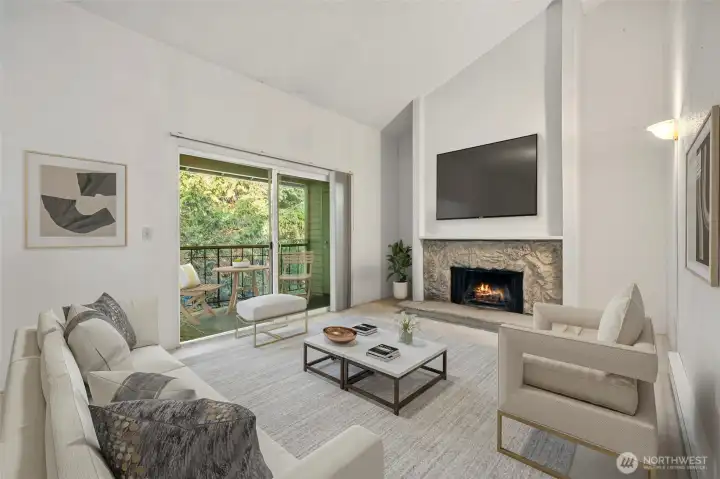 Cozy living room with a wood burning fireplace and private balcony overlooking the golf course