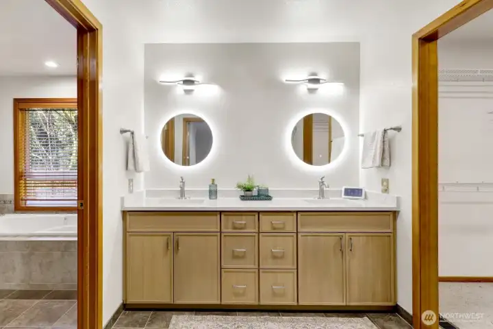 Lighted vanity with walk in closet to the R and bathrooom to the L.