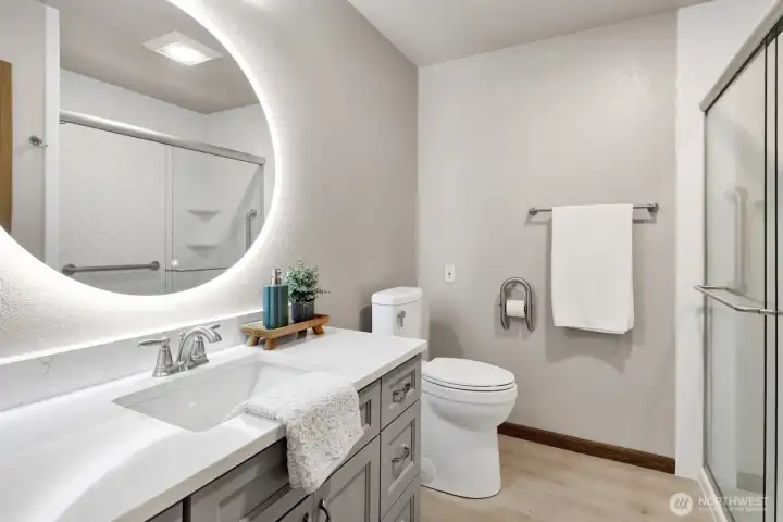 Updated guest bath with lighted vanity and easy walk in shower.