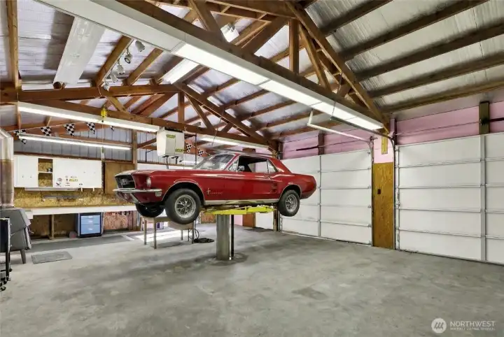 Shop with car lift, compressor, and air lines for your auto needs. Car virtually staged over car lift.