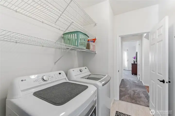 Laundry Room with storage racks, the washer and dryer are included.