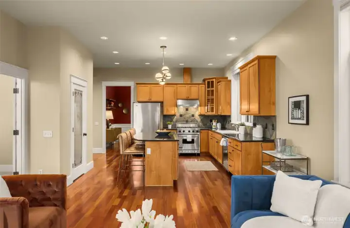 French doors lead to the main-floor bedroom (staged as an office).  Don't miss additional storage in the pantry located behind the eating bar.
