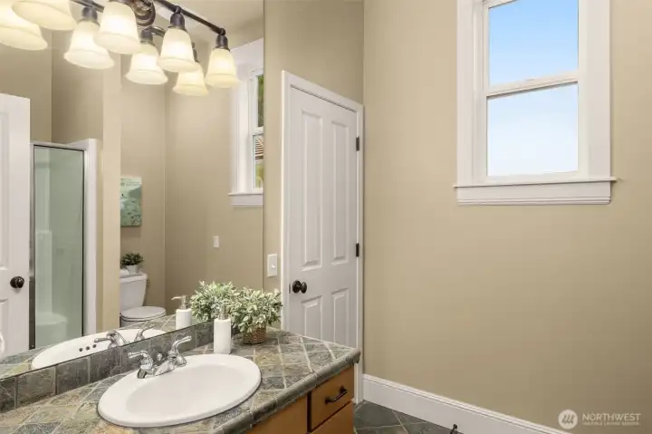 Main floor 3/4 bathroom with shower out of frame. Bathroom can be accessed from hall and from main floor bedroom/office.