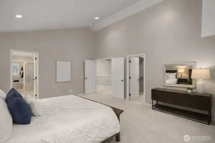 Double doors open onto this lovely primary suite, featuring 2 walk-in closets with custom-built closet systems and a 5-piece bath.