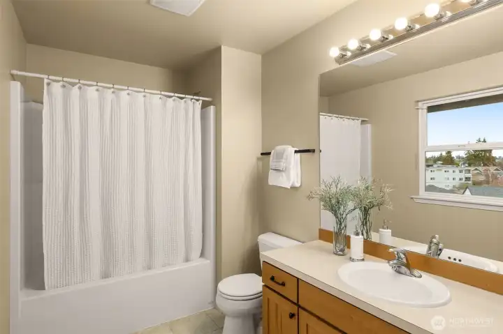 A full bath is located between the second and third bedrooms on the top floor.