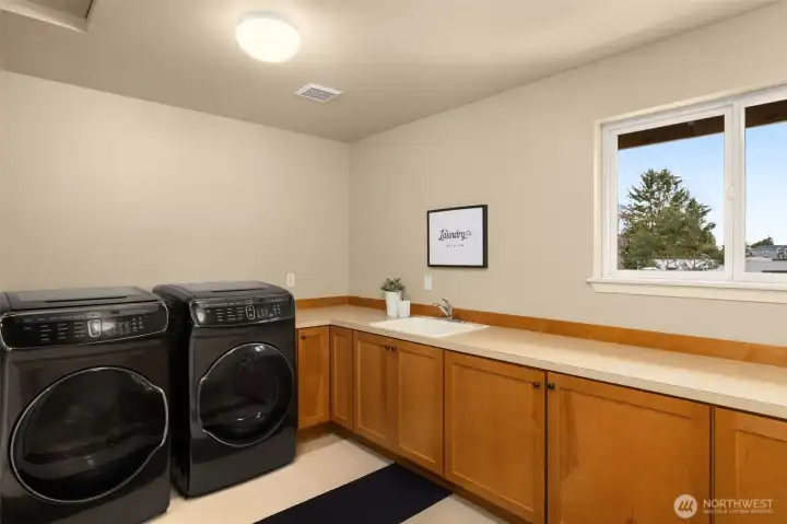 Folding & storage space abound in this huge top-floor laundry room.