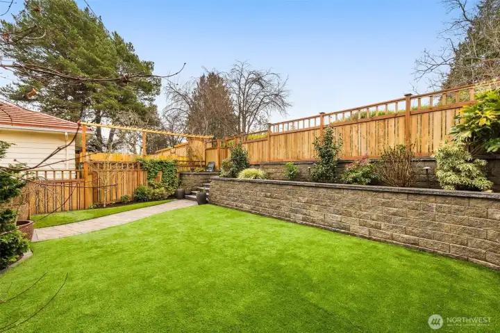 Over $100,000 spent on an extensive landscaping project to create this amazing in-city retreat.  Immaculate hardscaping with lighting, lush plantings, turf lawn (in front yard), fence that was placed according to the survey and surrounds the entire front and side yards, a drip watering system, & the environmentally conscious Rain Wise Cistern system.