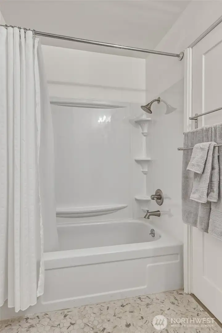 Guest bath has a full-sized tub/shower combo