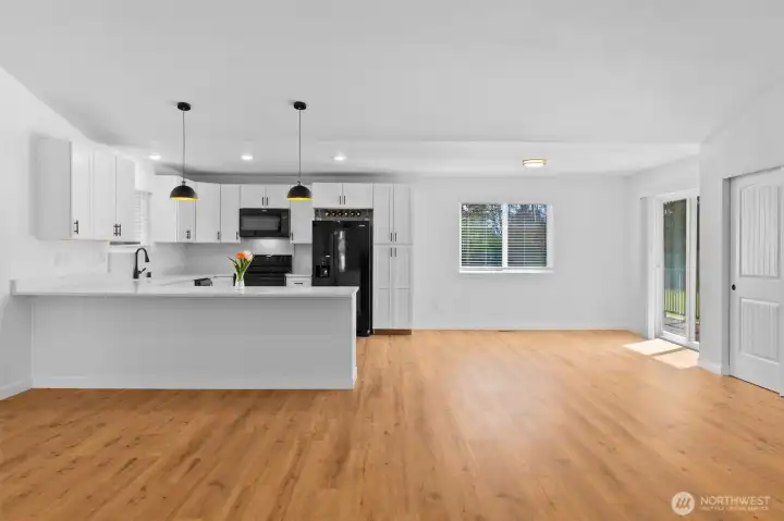 Place some breakfast stools at the counter, & also have a space for dining table