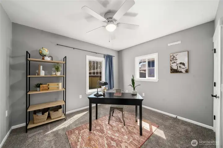 1 of 2 bedrooms on the main level - staged as an office but is a bedroom.