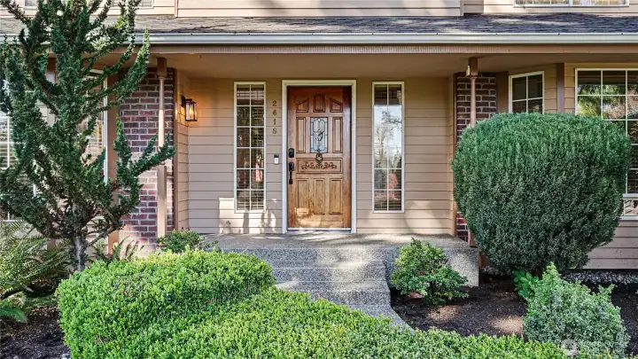 Relax on the cozy covered front porch, accented with glass panels and timeless brick detailing for added character.