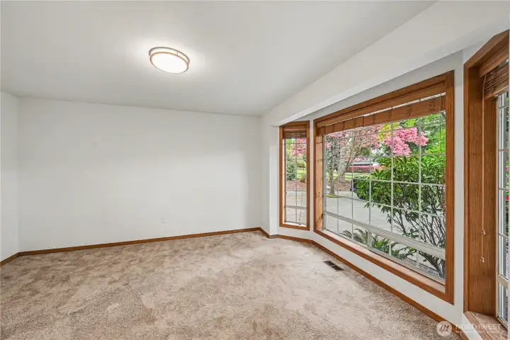 Step into a bright dining room positioned to the right of the entry, where large windows create an inviting space for gatherings.
