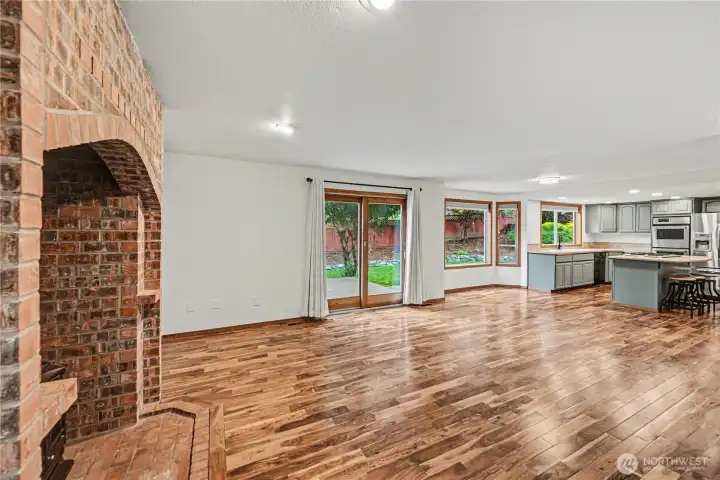 Sliding wood door opens to a spacious composite deck overlooking the fully fenced backyard.