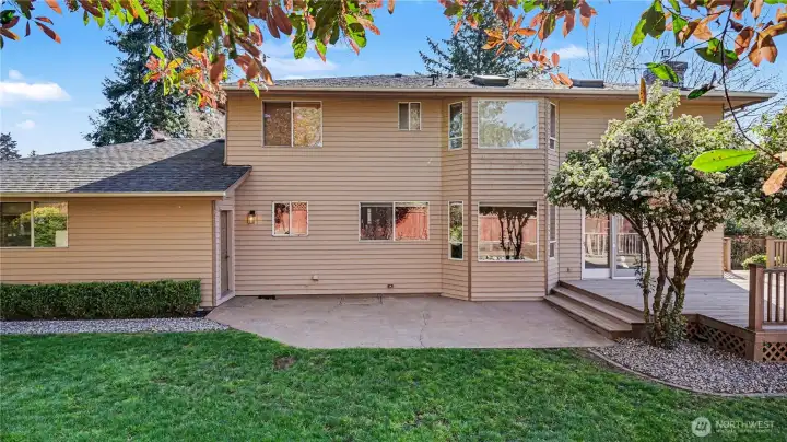 The backyard offers a large patio, firepit, storage shed, and beautifully maintained landscaping.