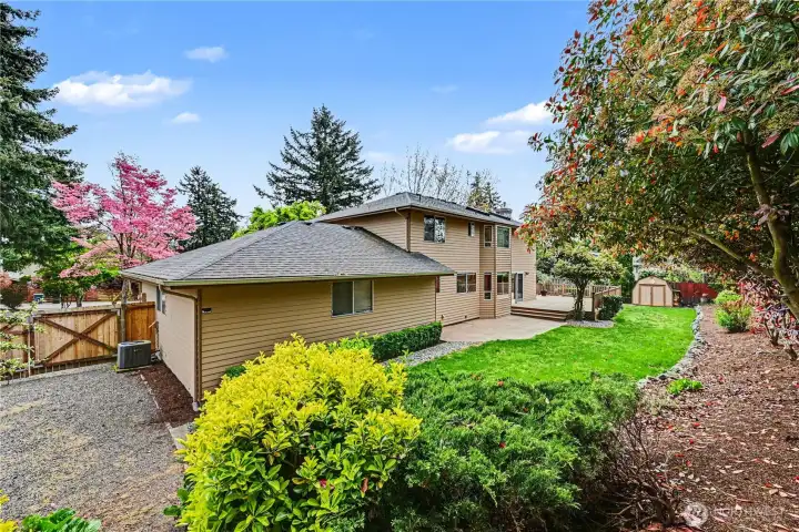 Lush, mature landscaping throughout enhances a backyard designed for effortless enjoyment.