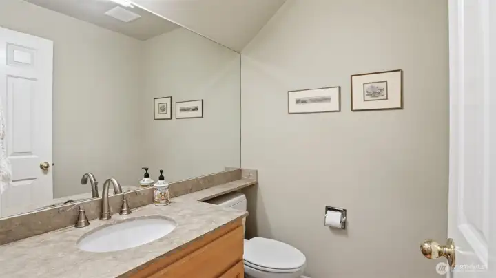 The main floor half bath has quartz counters.