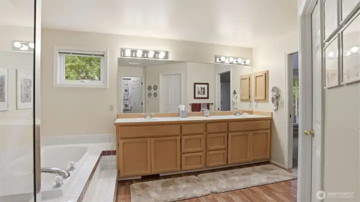 A large primary bath with a oversize shower, vaulted ceiling and a walk walk in closet.