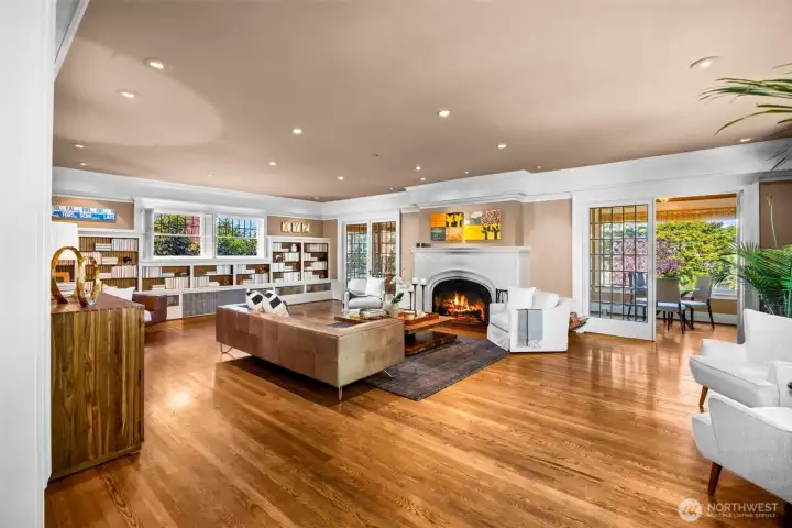 The main living space is designed for effortless gatherings, anchored by a comforting fireside hearth.