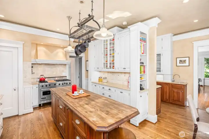 The culinary heart of the home features a rich wood island and premium finishes tailored for the modern chef.